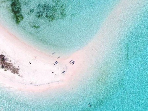 A sand bar in the middle of the sea.